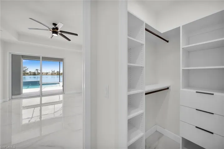 Spacious closet with ceiling fan