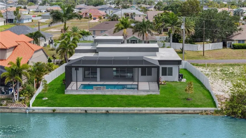 Rear view of property with a residential view, a water view, a fenced backyard, and a patio area