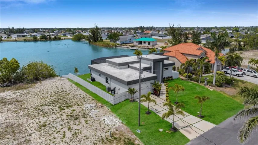 Birds eye view of property with a residential view and a water view
