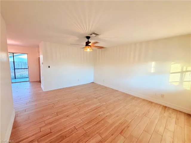 Spare room with light wood-style floors and a ceiling fan