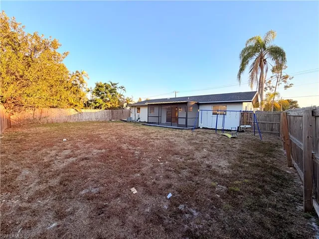 Back of property with a fenced backyard and a patio area