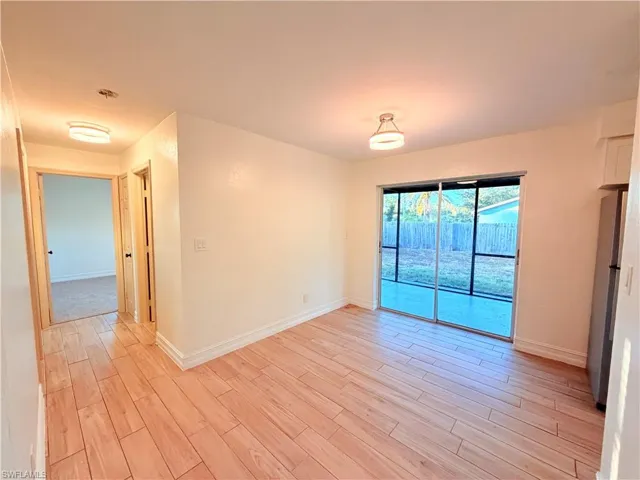 Empty room with light wood-type flooring and baseboards