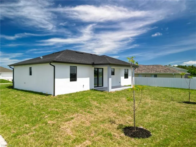 Rear view of house featuring a yard