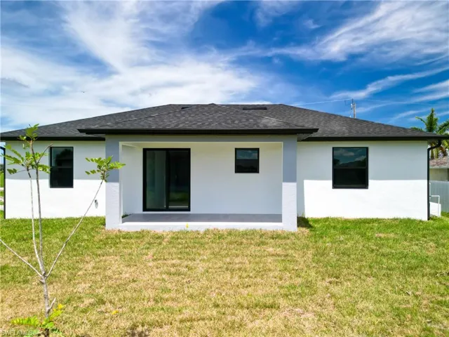 Back of property with a yard