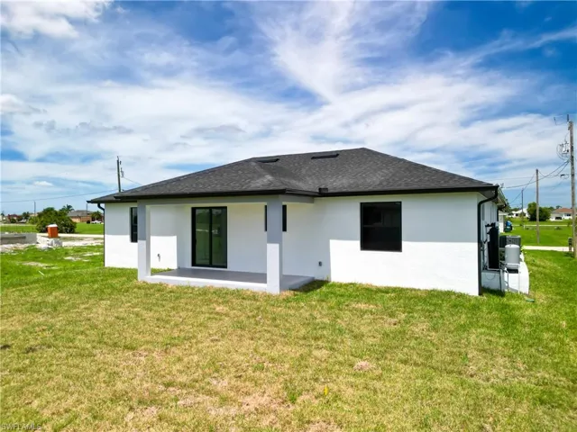 Back of property featuring a patio and a lawn
