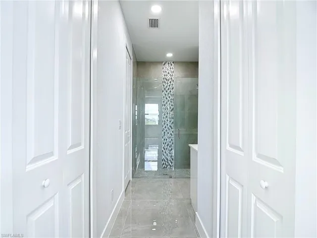 Hall with light tile flooring