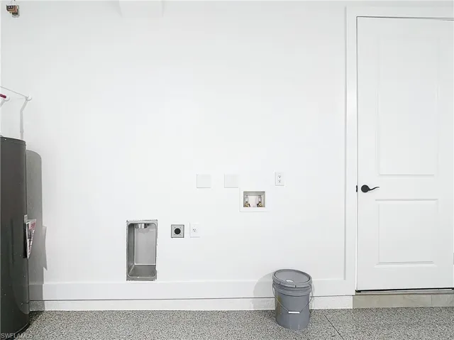 Washroom with tile floors, hookup for a washing machine, and hookup for an electric dryer
