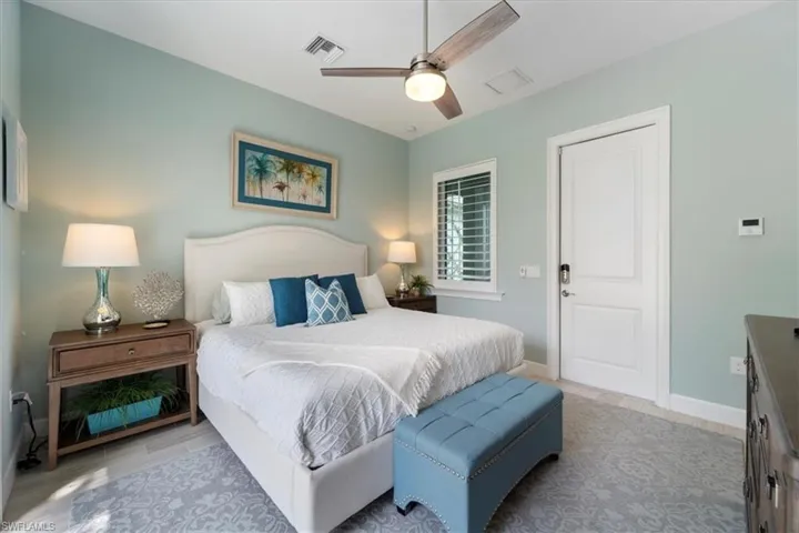 Bedroom with visible vents, ceiling fan, baseboards, and wood finished floors
