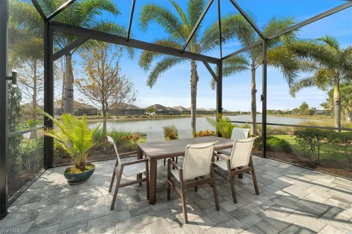 Sunroom / solarium with a water view and a wealth of natural light