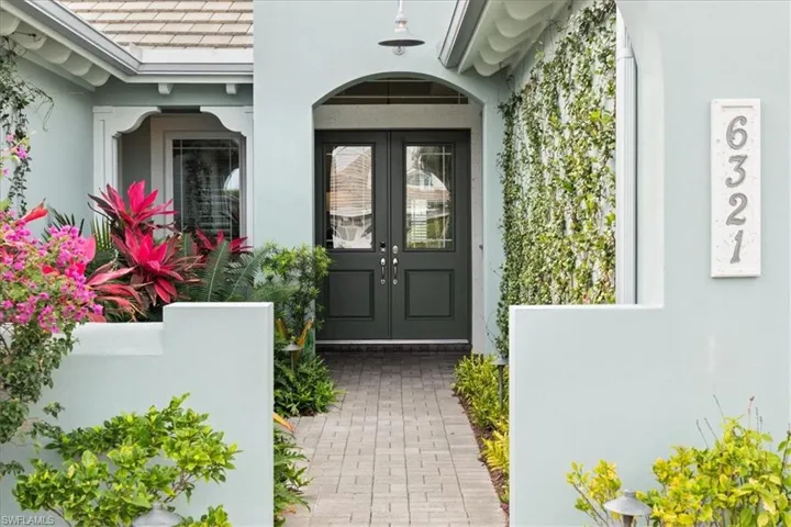 Doorway to property with french doors and stucco siding