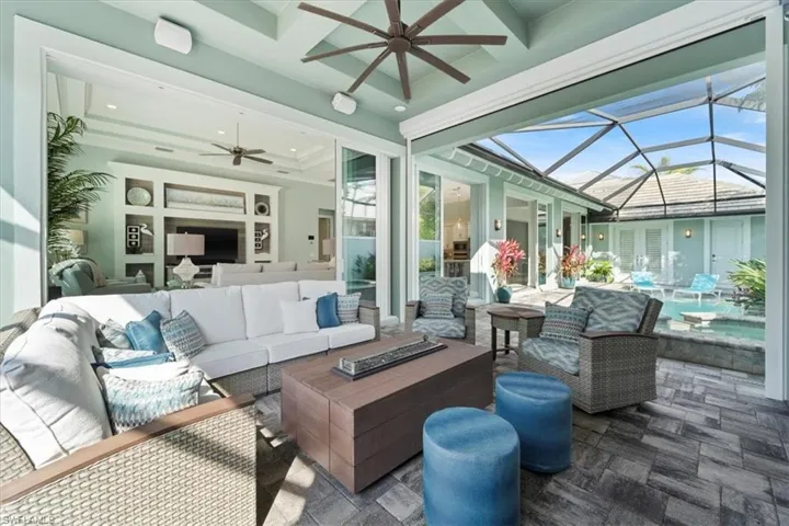 Sunroom with coffered ceiling and ceiling fan