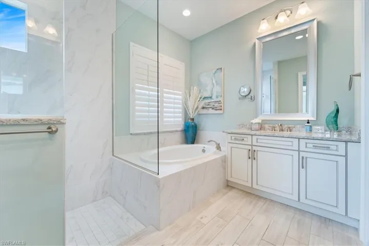 Full bathroom with a garden tub, vanity, and a walk in shower