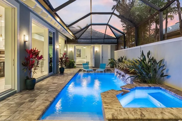 View of pool with a pool with connected hot tub and a patio