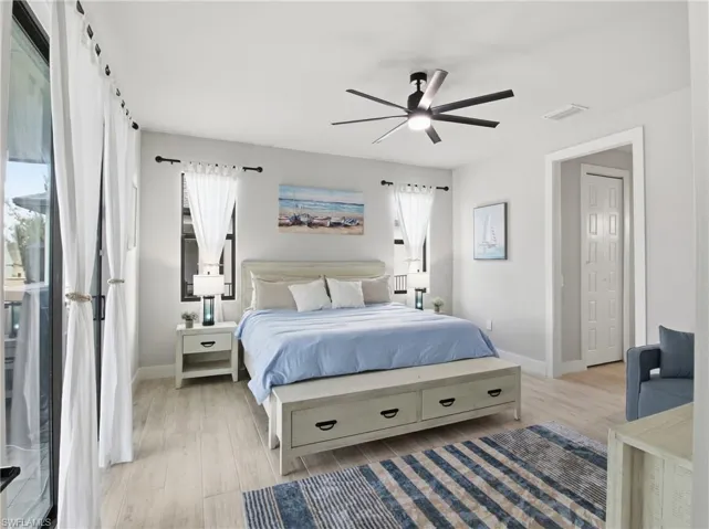 Bedroom featuring access to outside, light finished floors, and ceiling fan