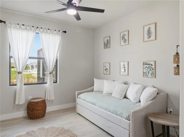 Bedroom featuring light finish floors and ceiling fan