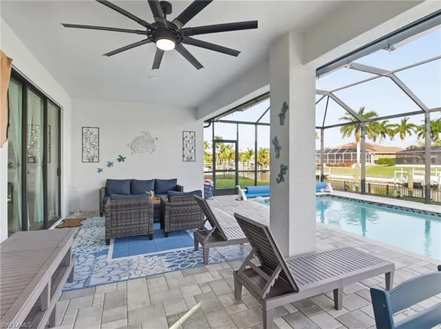 Swimming pool featuring a patio, an outdoor hangout area, a sunroom, and a screened enclosure