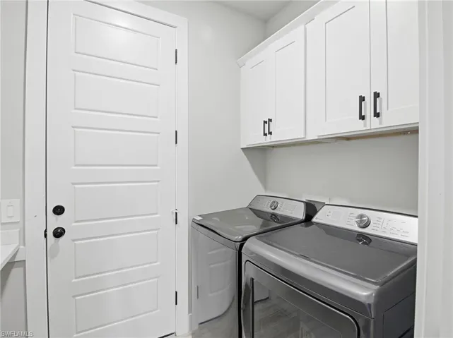 Laundry area with washing machine and dryer and cabinet space