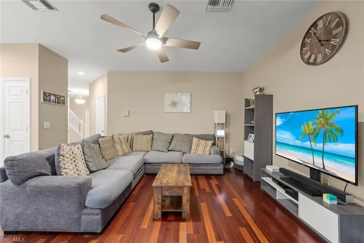 Family room with ceiling fan and wood-style flooring