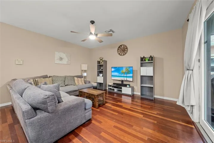 Family room with ceiling fan and wood-style flooring