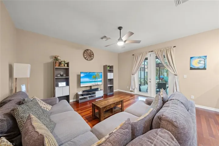 Family room with ceiling fan and wood-style flooring