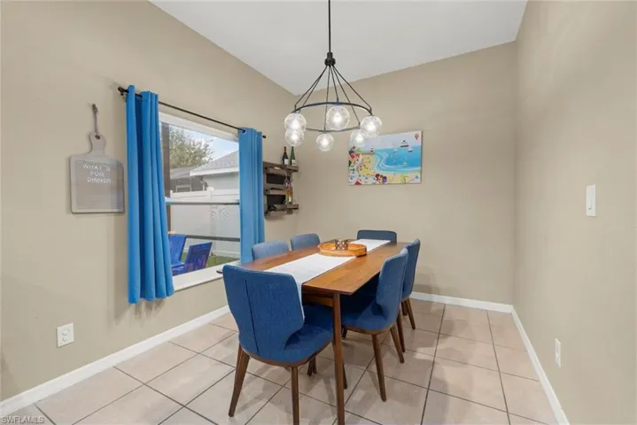 Dining area with a chandelier and light tile patterned floors