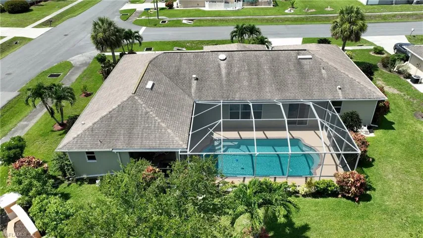 Aerial view of property and surrounding area with a pool