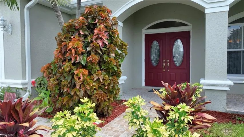 Entrance to property with stucco siding