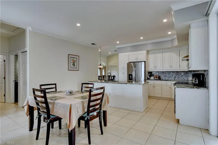 Dining room featuring ornamental molding, recessed lighting, and light tile patterned floors