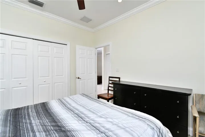 Bedroom featuring ornamental molding, a closet, and a ceiling fan