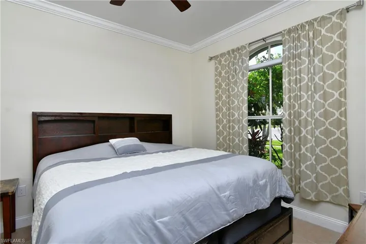 Bedroom with crown molding and a ceiling fan