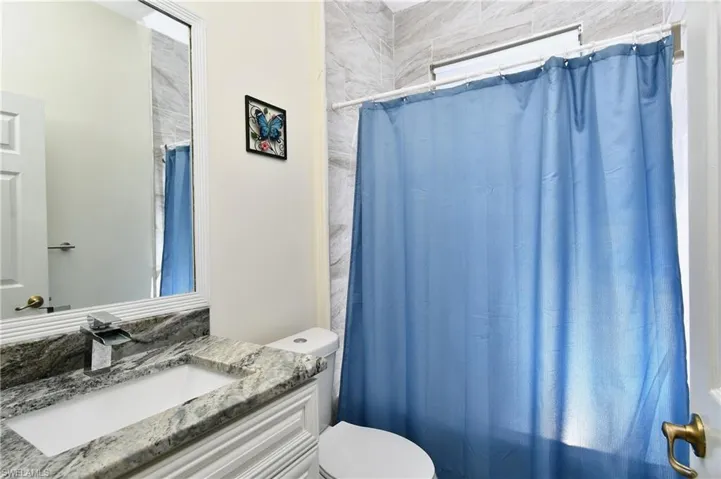 Full bathroom with vanity and toilet