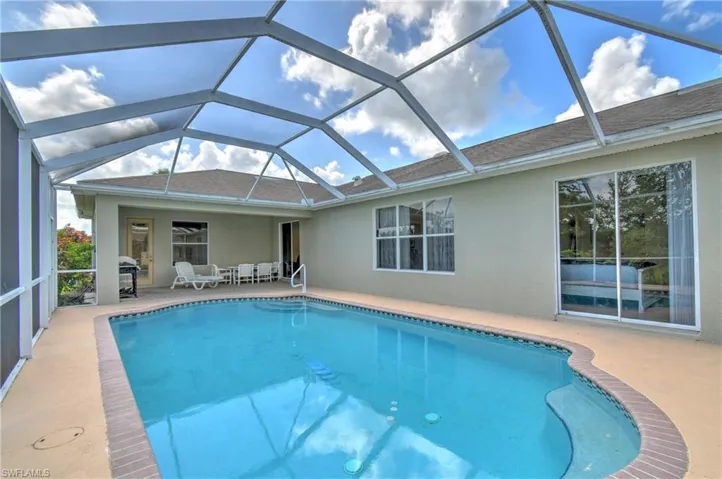 Outdoor pool featuring a patio and a lanai