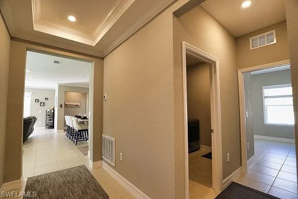 Living area with ceiling fan, recessed lighting, and ornamental molding