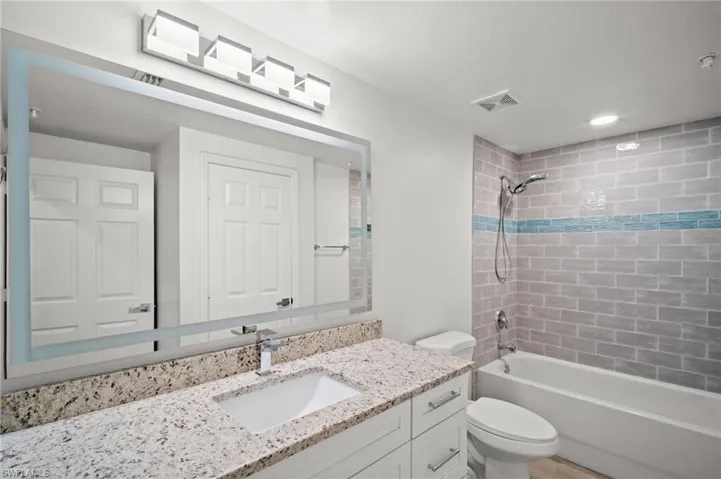 Full bathroom featuring vanity and shower / washtub combination