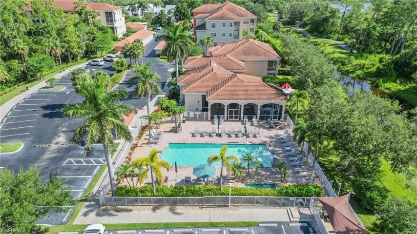 Aerial view of a pool area and a tree filled landscape