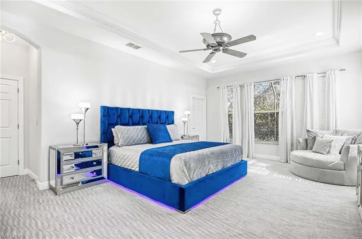Primary bedroom with stylish bed featuring LED lighting