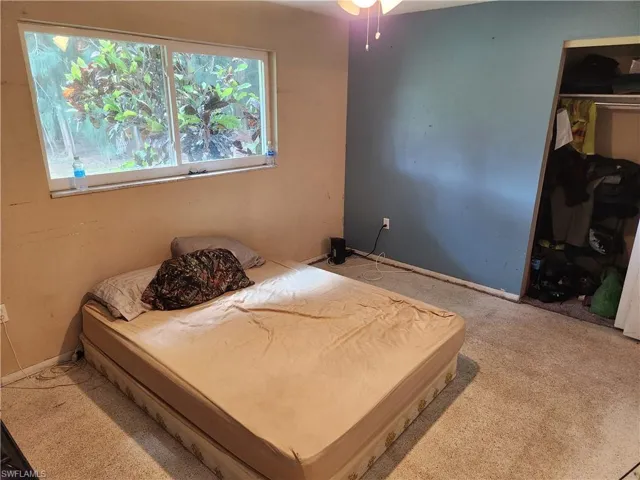 Bedroom featuring carpet flooring and a closet