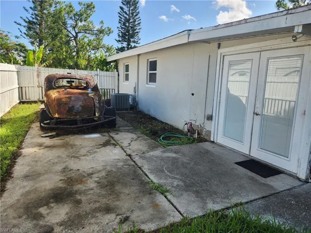 Fenced backyard featuring a  enclosed florida room and french doors