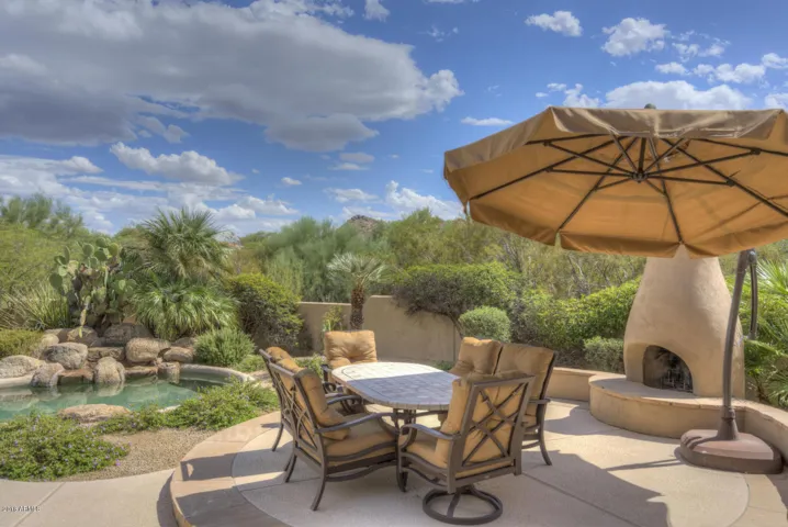 Dining poolside with kiva fireplace