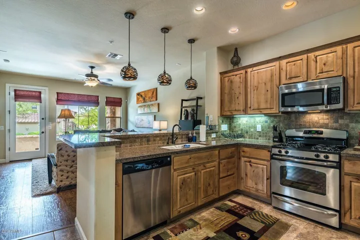 Kitchen with stainless steel appliances, granite counter-tops and oak cabinets