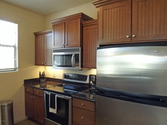 Kitchen with stainless steel appliances and fully stocked.