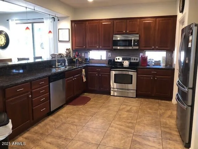 Kitchen with Stainless Appliances, Cherry Raised-Panel Cabinet and Granite Counters