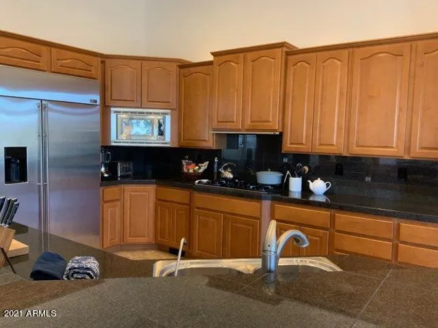 Kitchen with gas cooktop, stainless appliances, dual wall ovens and granite countertops!