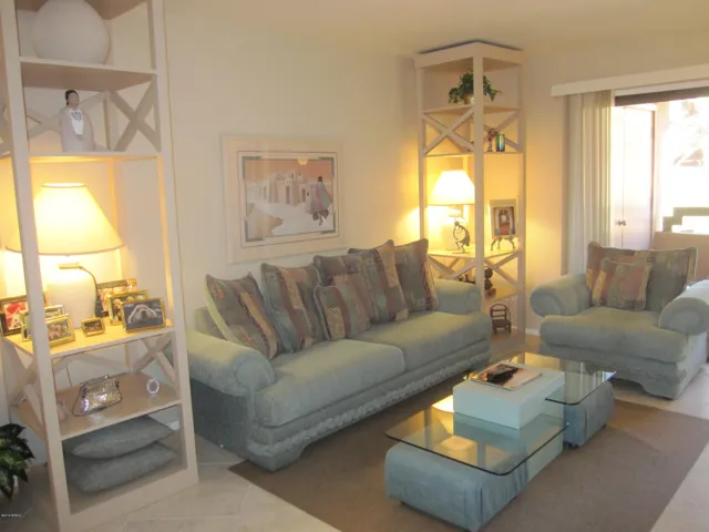 Stylish sofa and chair plus two etageres filled with fun decor