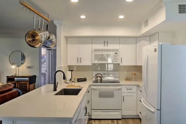 The open kitchen with bar seating looks into the family room to keep everyone connected.