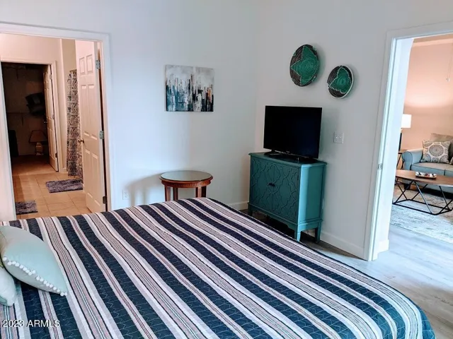 Primary ensuite features flat screen TV. The bath with dual sinks, walk in closet