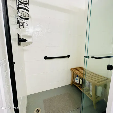 Walk in shower has a bench and safety bars!