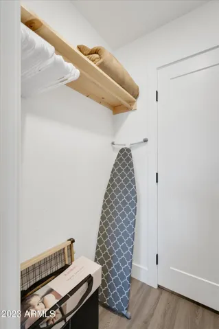 The primary bedroom closet comes with many extras - blankets, towels, iron and ironing board, baby gate, Baby Bjorn travel crib, and more!