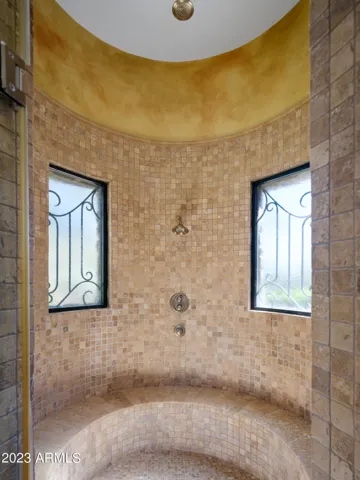 Primary bathroom with dual vanities, large walk in shower, and jetted tub.