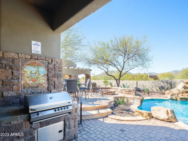 Stunning Cave Creek home with sparkling pool, spa, covered patio with shuffle board, outdoor dining, BBQ grill, fire pit, sun loungers, and private guest casita that features a sauna!